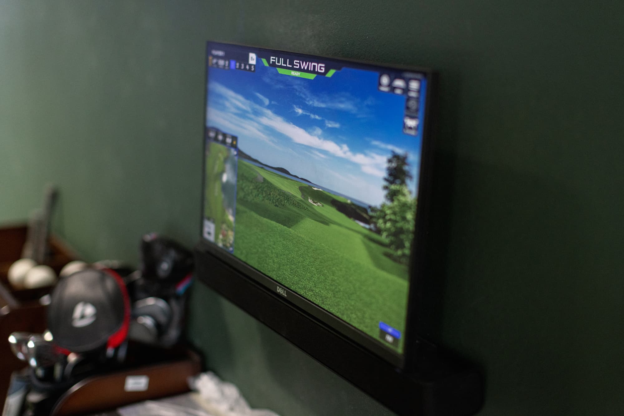 Full Swing simulator screen rendering a real golf course at Rev's Golf Lounge